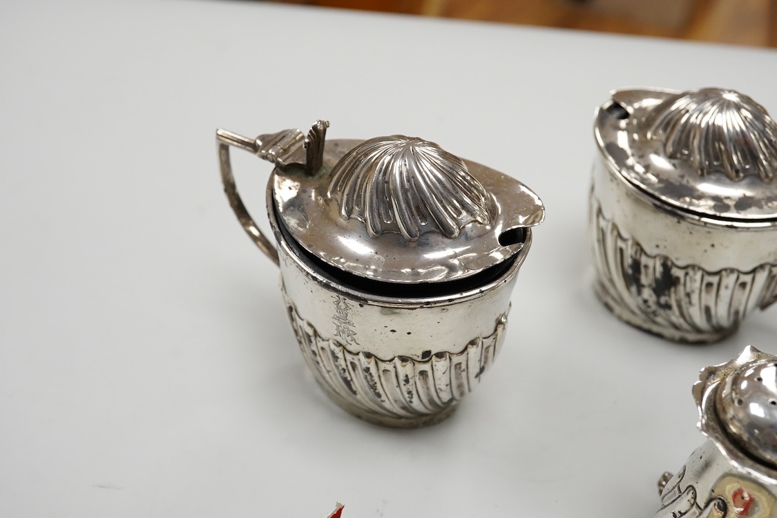 A George V silver octagonal sugar caster, Viners Ltd, Sheffield, 1932, 18.2cm, an Edwardian silver three piece condiment set by John Round, a silver napkin ring and three silver spoons including a dessert spoon by Peter,
